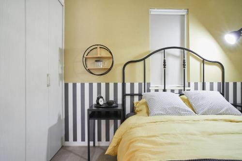 a bedroom with a bed with a black and white striped wall at Beautiful Villa in Shinjuku Shin-OKubo 6minutes walk B in Tokyo