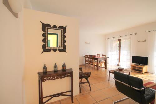 a living room with a mirror and a table at Casa Sol with private terrace, garden, pool, beautiful view in Port de Soller