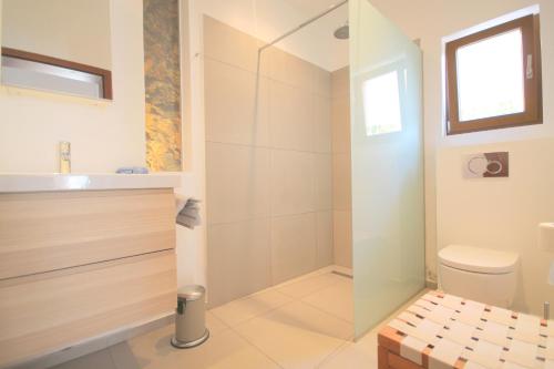 a bathroom with a shower and a toilet at Casa Sol with private terrace, garden, pool, beautiful view in Port de Soller