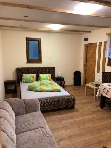 a bedroom with a bed and a couch at Glückliche Elfen in Sankt Kathrein am Hauenstein
