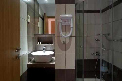 a bathroom with a sink and a shower at Karalis Beach in Pylos
