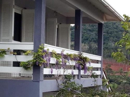 a house with purple flowers on the side of it at Casa Deni in Nova Petrópolis