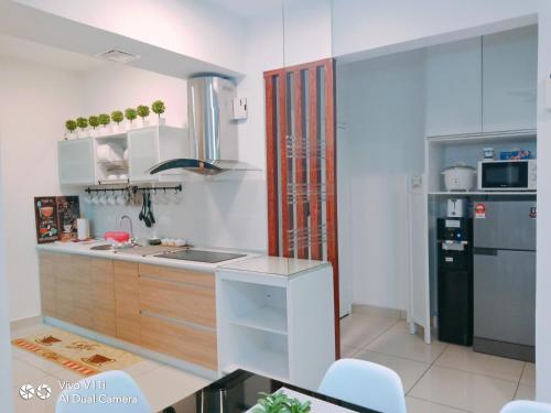 a small kitchen with a sink and a refrigerator at Evo Bangi Duplex Homestay D' Imahzzz - 3BR or 2BR in Bangi