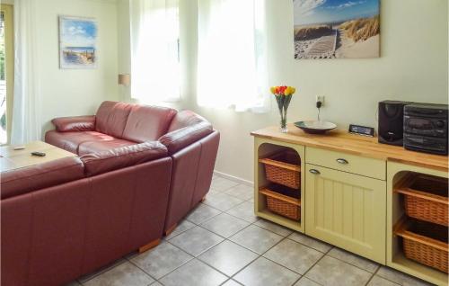 a living room with a couch and a microwave at Oesterbaai 6 in Wemeldinge