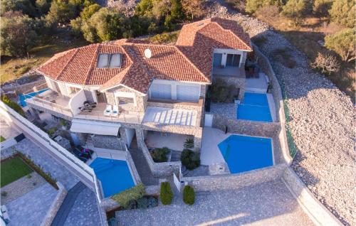 an aerial view of a house with two swimming pools at 2 Bedroom Gorgeous Home In Krk in Krk
