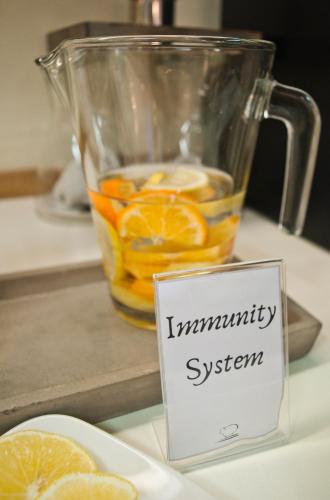 a glass pitcher filled with oranges on a table at Hotel Miramonti in Schio