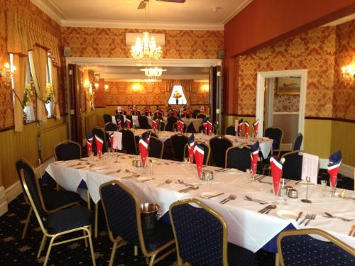 a conference room with a long table and chairs at Furzedown Hotel in Great Yarmouth