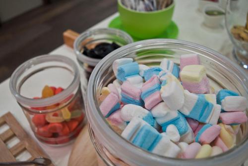 a glass jar filled with marshmallows and other candy at Hotel Miramonti in Schio