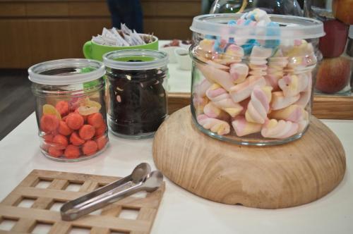 a jar of marshmallows and other candy on a table at Hotel Miramonti in Schio