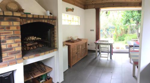 a living room with a brick fireplace and a table at La Case O zoizos in Saint-Joseph