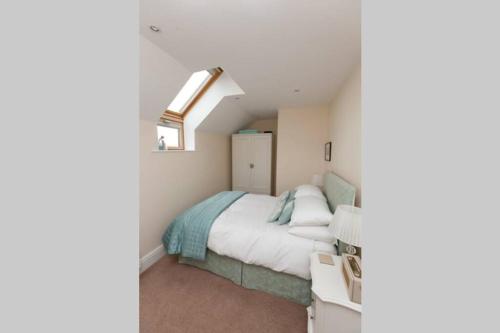 a small bedroom with a bed and a window at RED LION LOFT BLIDWORTH in Blidworth