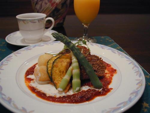a plate of food on a table with a drink at Pension Pure in Iiyama