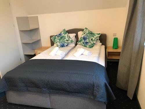 a bedroom with a bed with pillows on it at Apartamenty Pod Zamkiem w Janowcu in Janowiec