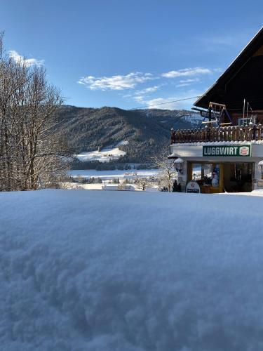 a pile of snow in front of a building at Gasthaus Luggwirt in Gnesau