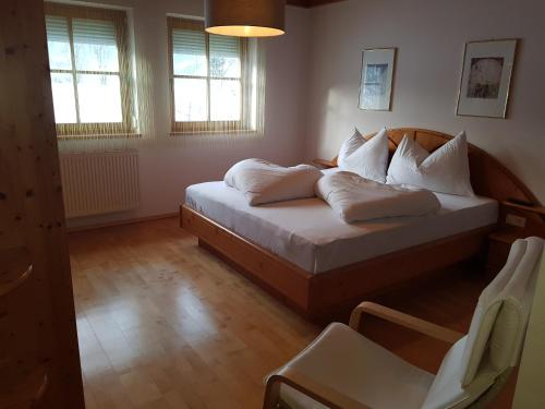 a bedroom with a bed with white pillows on it at Ferienhaus Kahr Appartment Ennstal in Radstadt