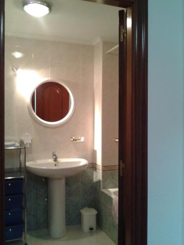 a bathroom with a sink and a mirror at Angoiko Etxea in Bacáicoa