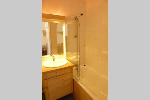 a bathroom with a tub and a sink and a bath tub at val thorens appartement 4 personnes ski aux pieds in Val Thorens