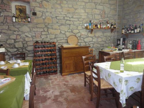 a restaurant with a table and chairs and a wine cellar at Agriturismo La Capitata in Pian di Scò