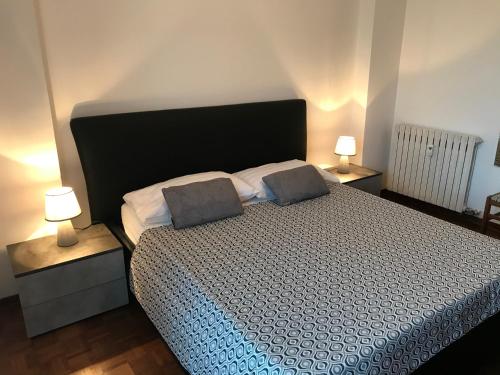 ein Schlafzimmer mit einem Bett mit zwei Kissen darauf in der Unterkunft Appartamento Lake Como in Gravedona