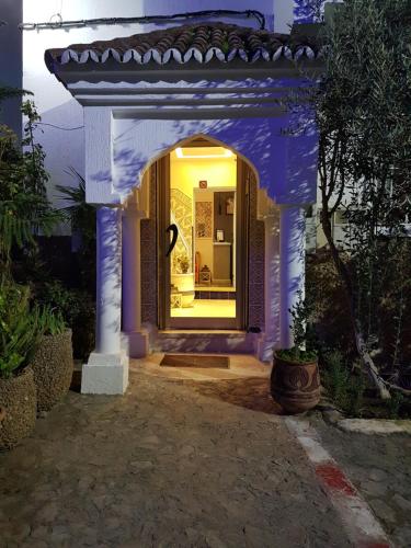an entrance to a house with a blue archway at Maison d'hôte Bousaid in Chefchaouene