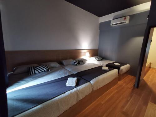 a bedroom with a large bed in a room at Tatami D'Tepi Laut - PANGKOR ISLAND in Pangkor