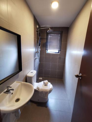 a bathroom with a toilet and a sink at Tatami D'Tepi Laut - PANGKOR ISLAND in Pangkor