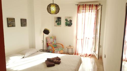 a bedroom with a bed with two brown towels on it at Gran Vía flat in Ceuta