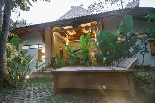 a bench sitting in front of a house at Adara Homestay in Banyuwangi