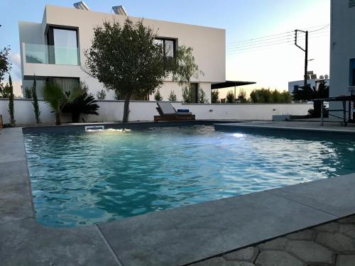 a swimming pool in front of a house at Villa Amor in Pefki Rhodes