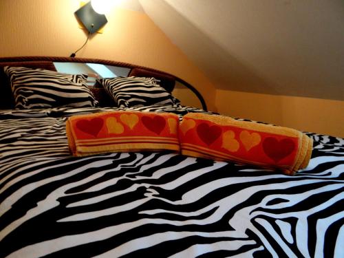 a bed with black and white sheets and pillows at Šubrakkrasti in Vestiena