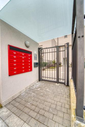 a red door on the side of a building at CaseOspitali - Casa Azzurra, incantevole bilocale con giardino in Cernusco sul Naviglio