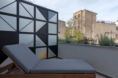 a chair sitting on top of a balcony at Athenian Lofts in Athens