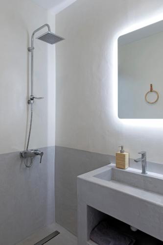 a bathroom with a sink and a mirror at Athenian Lofts in Athens