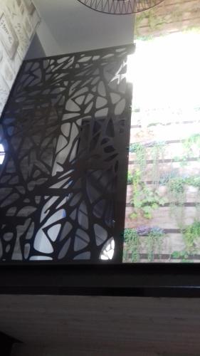 a shadow of a tree on the wall of a window at Gite le port sur mer in Cugand