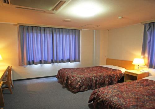 Säng eller sängar i ett rum på Bayside Hotel Ryugu / Vacation STAY 63714