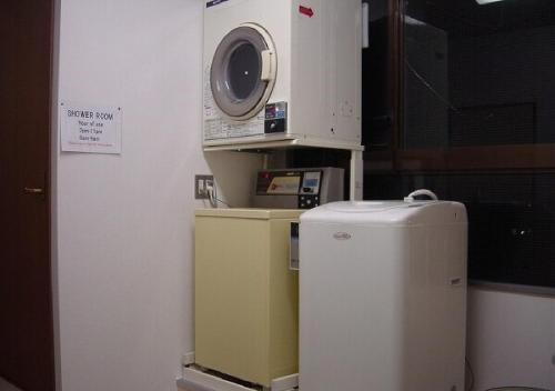 a kitchen with a microwave and a small refrigerator at kawagutiko station inn / Vacation STAY 63735 in Azagawa