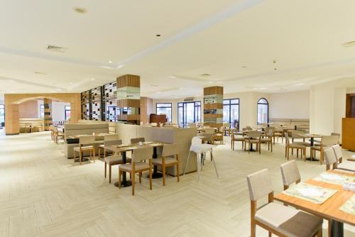 a restaurant with tables and chairs and a bar at Amphoras Beach - Ultra All Inclusive in Sharm El Sheikh
