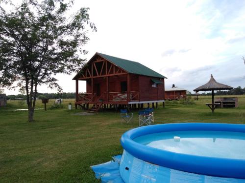 a house and a pool in a yard with a building at Cabañas Jamakimel in Uribelarrea