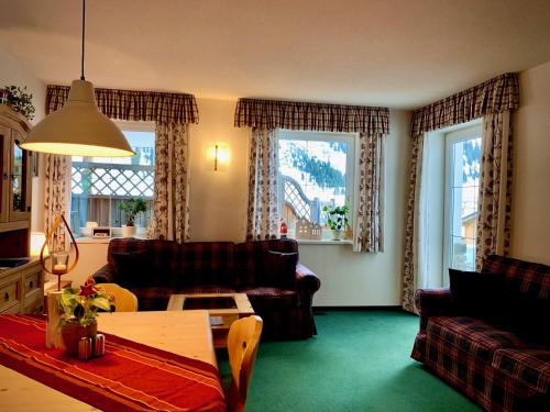 a living room with a couch and a table at Haus Bergwelt - Appartements in Lech am Arlberg