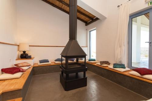 a room with a fireplace in a house at Monte da Estrela - Country House & SPA in Moura