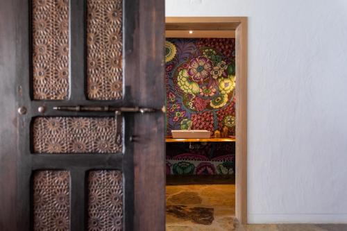 a door in a room with a colorful wall at Monte da Estrela - Country House & SPA in Moura