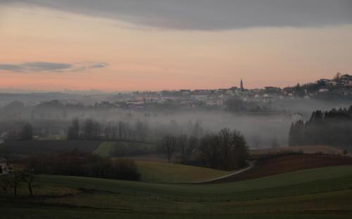 a foggy field with a city in the background at Appartement Hauzenberg-Panorama in Hauzenberg