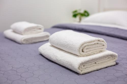 two beds with white towels on top of them at Cozy apartments center in Lviv
