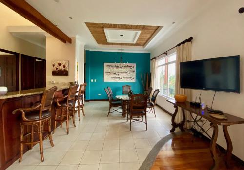 a kitchen and dining room with a table and chairs at Palm Coast Luxury Rentals in Esterillos Este