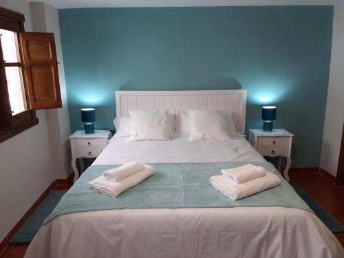 a bedroom with a bed with two towels on it at La Calleja del Canchal in Arenas de San Pedro