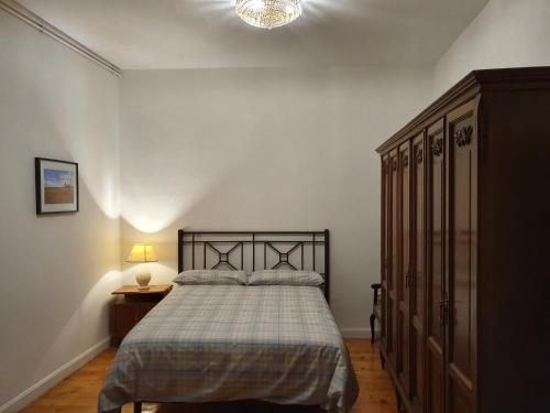 a bedroom with a bed and a dresser at Casa burguesa de 1900 in Valladolid