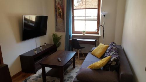 a living room with a couch and a tv at Na Rynku in Gliwice