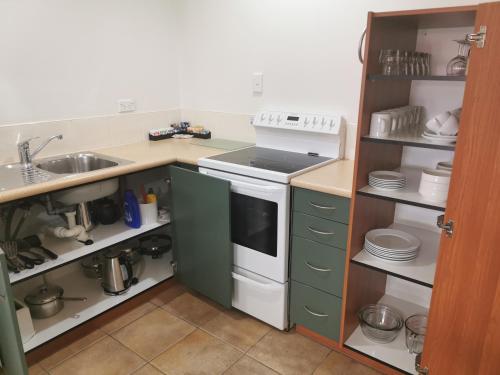 a kitchen with a sink and a stove at Bks Egmont Motor Lodge in New Plymouth