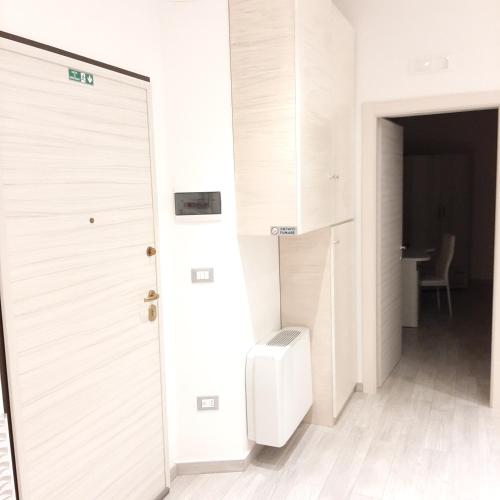 a bathroom with a white door and a toilet at La Casa di Bea in Magliano deʼ Marsi