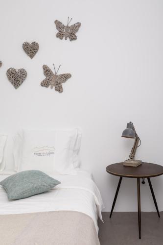 a bedroom with butterflies on the wall next to a bed at Monte da Estrela - Country House & SPA in Moura